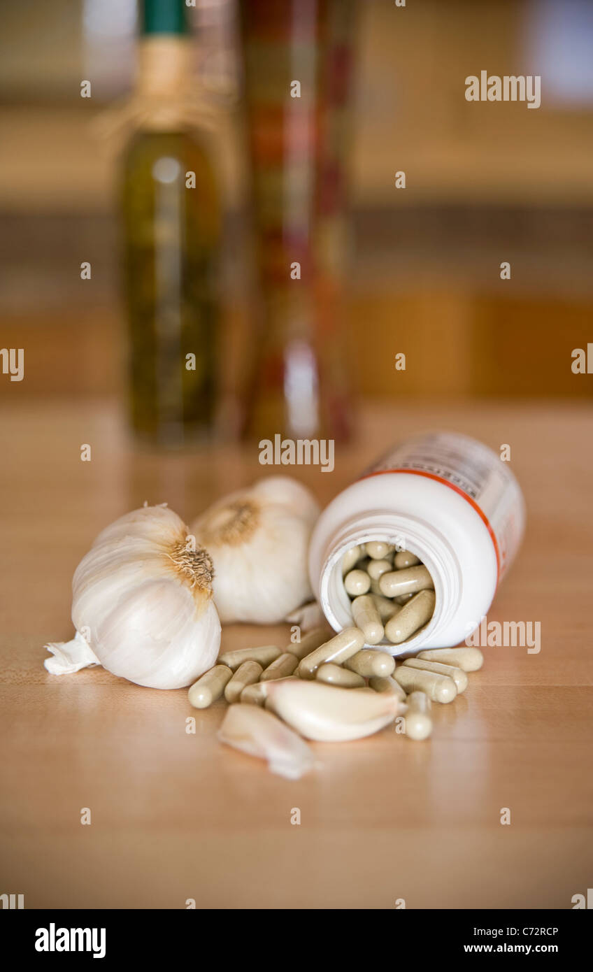Aged Garlic capsules in a still life arrangement with garlic cloves