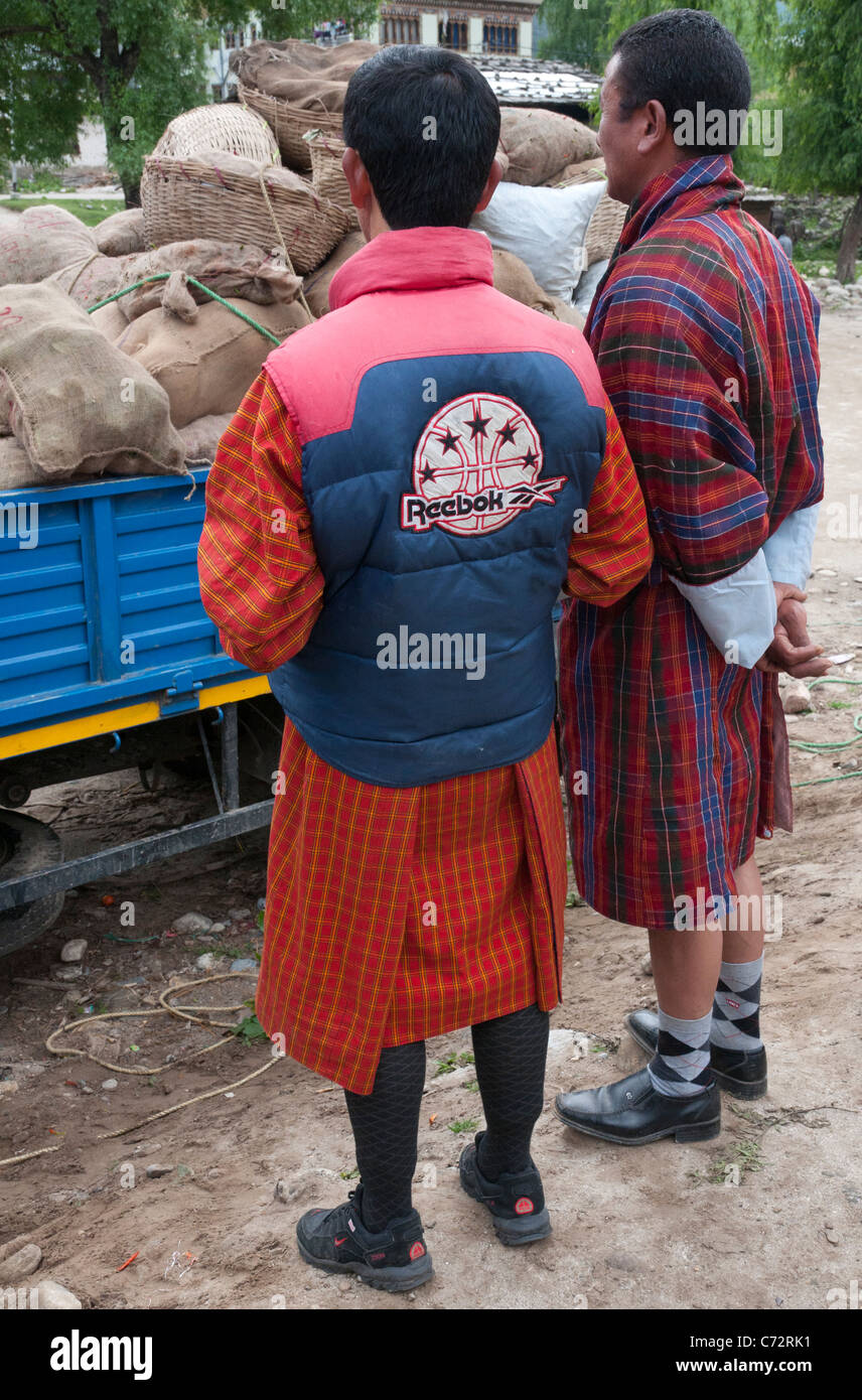 two men in traditional gho at the sunday market. Haa. bhutan Stock Photo