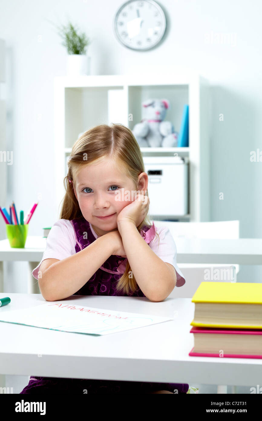 Portrait of lovely girl sitting at workplace in classroom Stock Photo ...