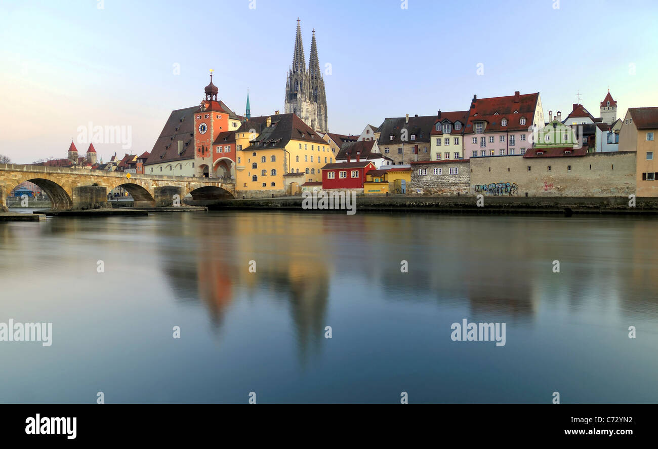 This photo shows Regensburg town in Bavaria with its famous medieval stone bridge, the Dom Cathedral and the Brucktor City Gate. Stock Photo