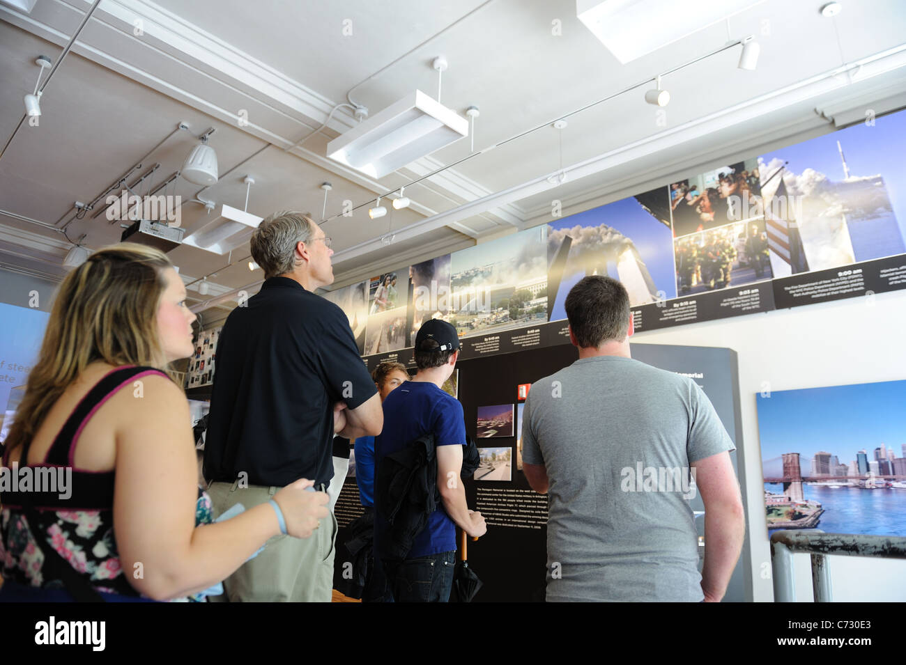 Visitors to the 9/11 Memorial Preview Site see photographs and a video relating to the attack on the World Trade Center in 2001. Stock Photo