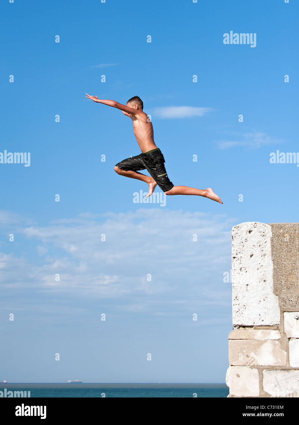 A boy tombstoninbg off the harbour arm in Margate. Stock Photo