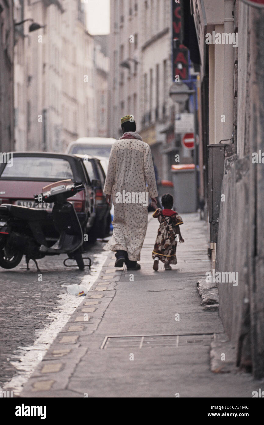 Immigrant father with child in the African Quarter, Barbes in the 18, 19e Arrondissement, Paris, France Stock Photo