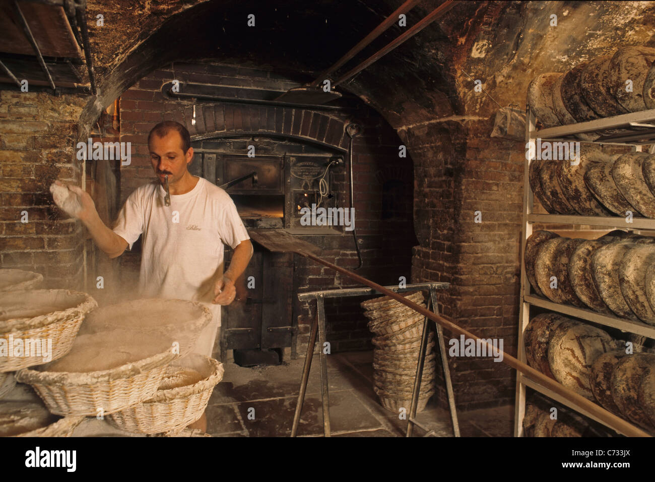 Baker baking bread in the bakery, wood-fired oven, Boulangerie in Saint  Germain des Pres, Paris, France Stock Photo - Alamy