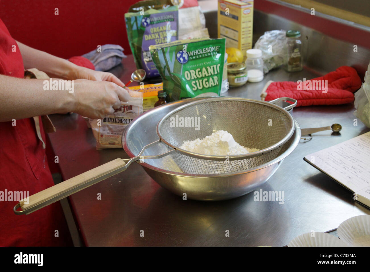 A person mixing and sifting ingredients for cake Stock Photo Alamy