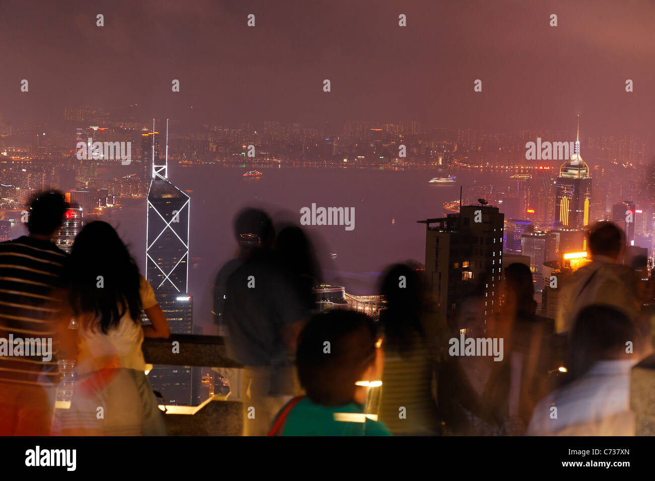 Tourists taking in view of downtown Hong Kong from Victoria Peak at night, Hong Kong SAR, People's Republic of China, Asia Stock Photo