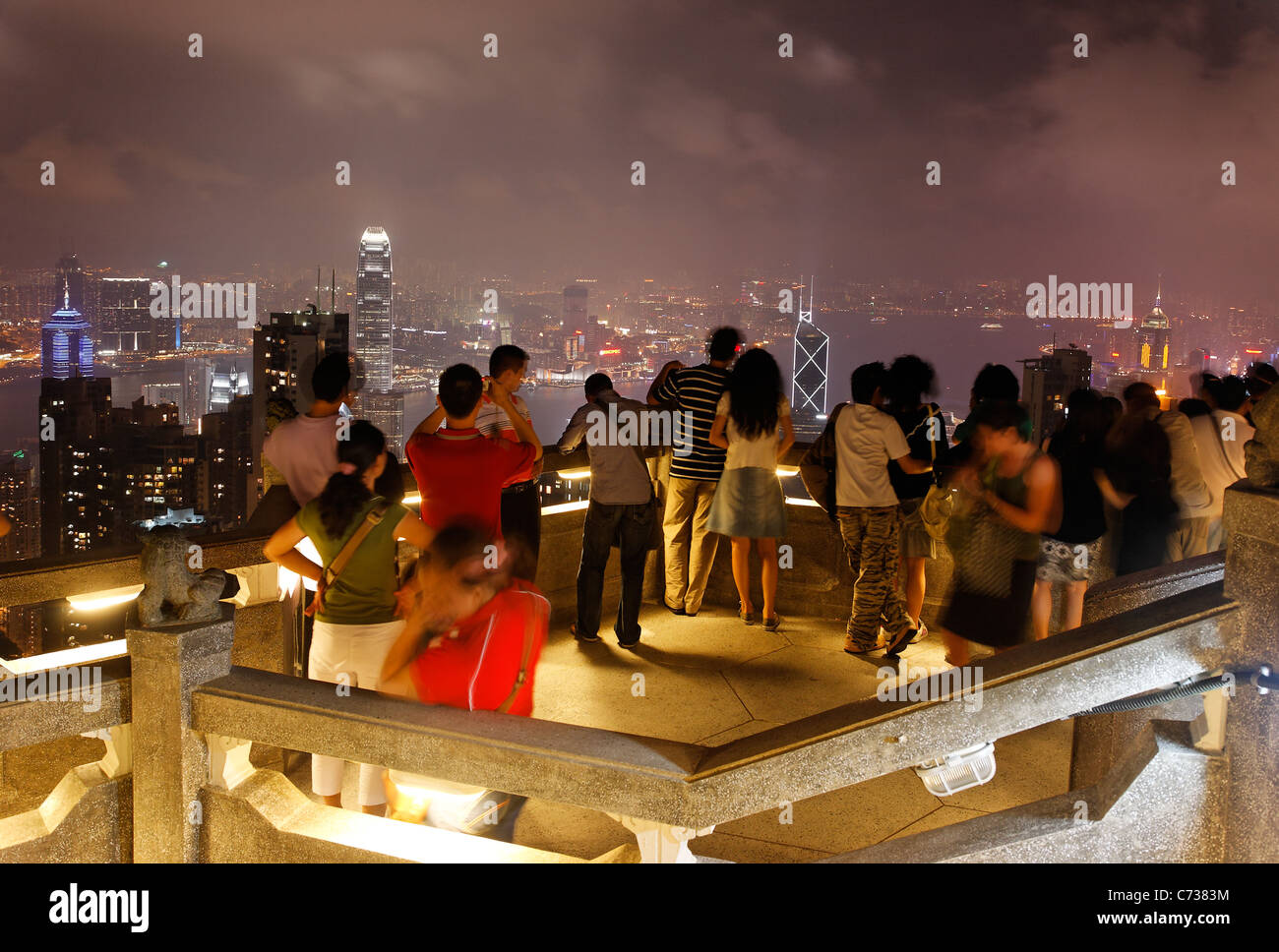 Tourists taking in view of downtown Hong Kong from Victoria Peak at night, Hong Kong SAR, People's Republic of China, Asia Stock Photo