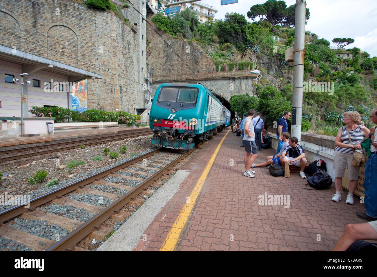 Train arrives at fishing village Riomaggiore, National park Cinque Terre, Unesco World Heritage site, Liguria di Levante, Italy, Mediterranean sea Stock Photo