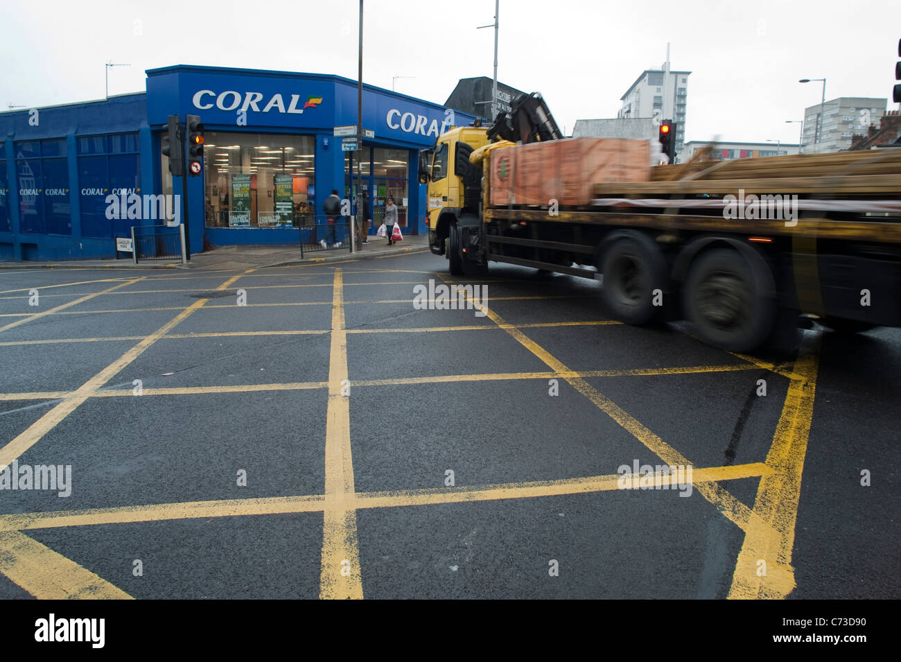 A big lorry crossing the box junction and turning into another street. Stock Photo