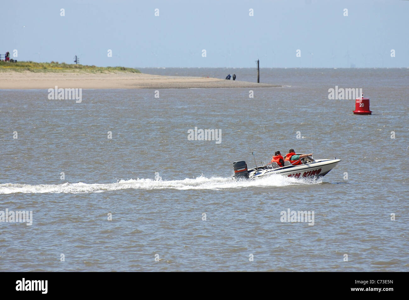 Small speedboat heading out to sea from the Wyre Estuary Stock Photo