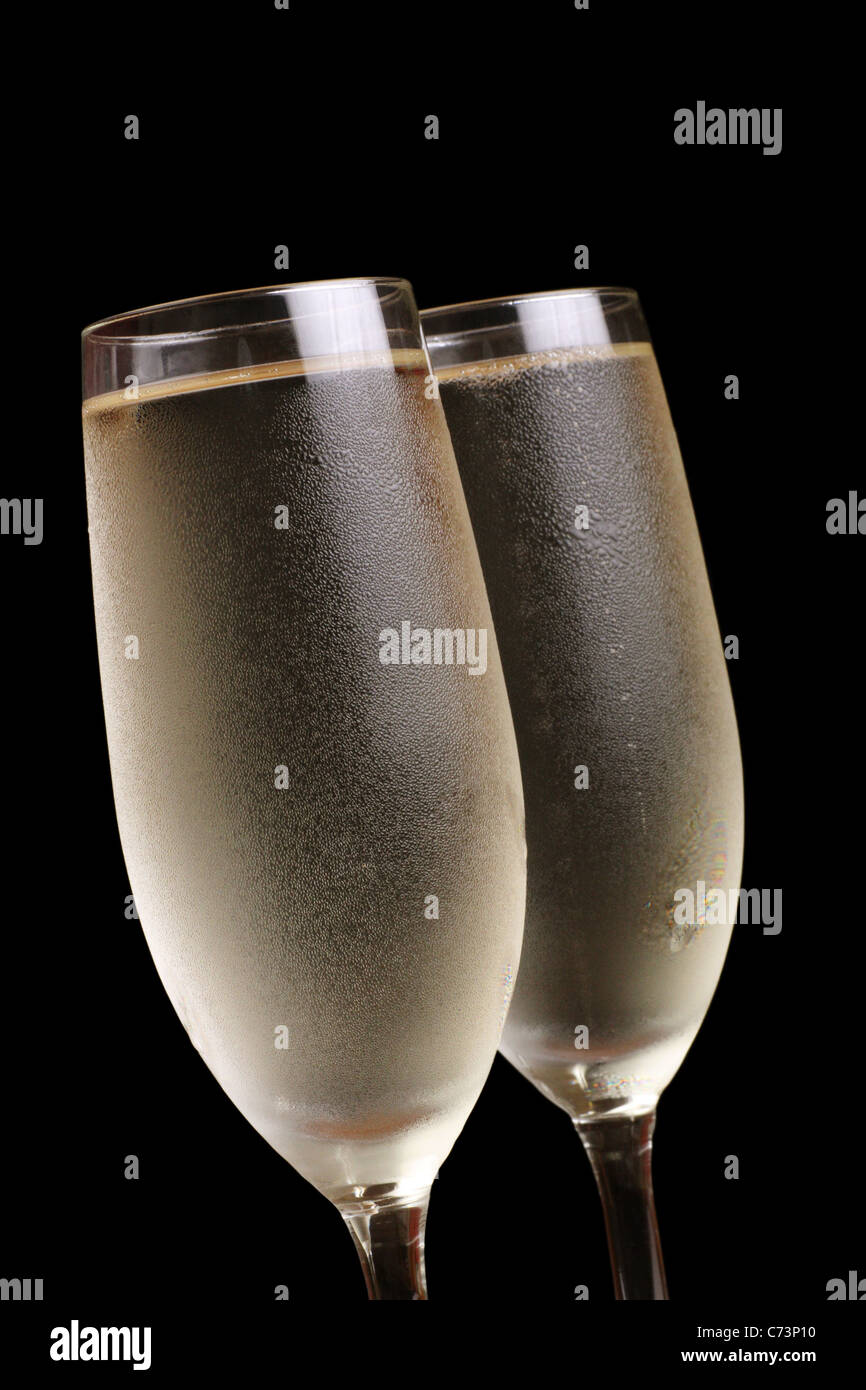 two glasses of chilled champagne showing condensation and bubbles Stock