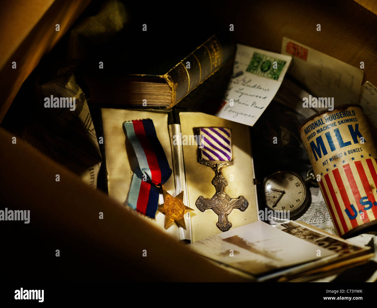 box of old items, featuring two military medals Stock Photo Alamy