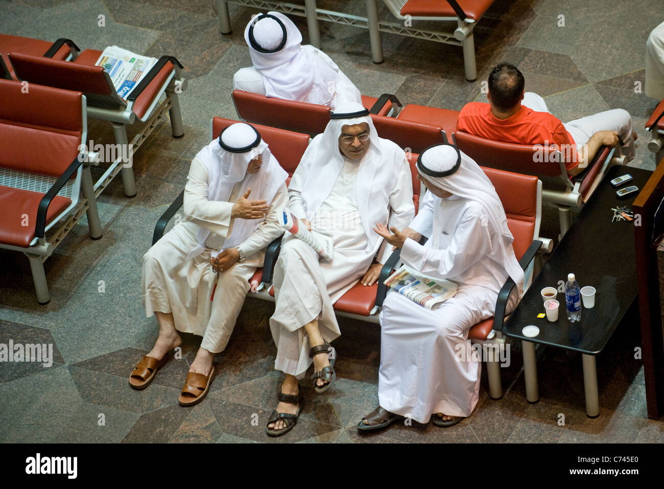 Three men discussing at the stock exchange Kuwait City Kuwait Stock Photo