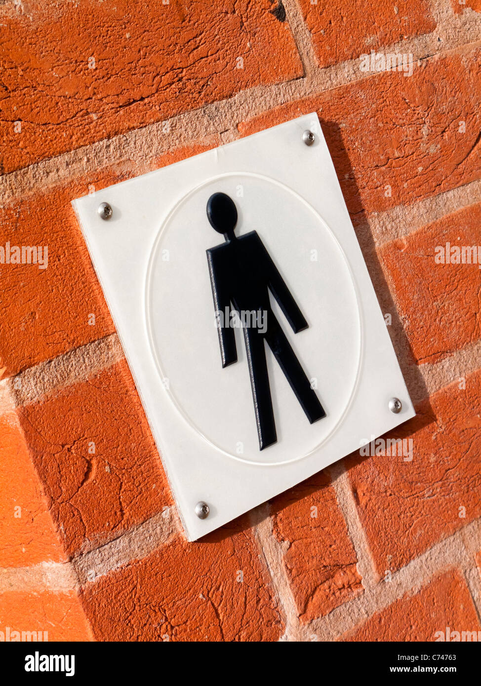 Tactile plastic sign outside public toilet with Braille text for