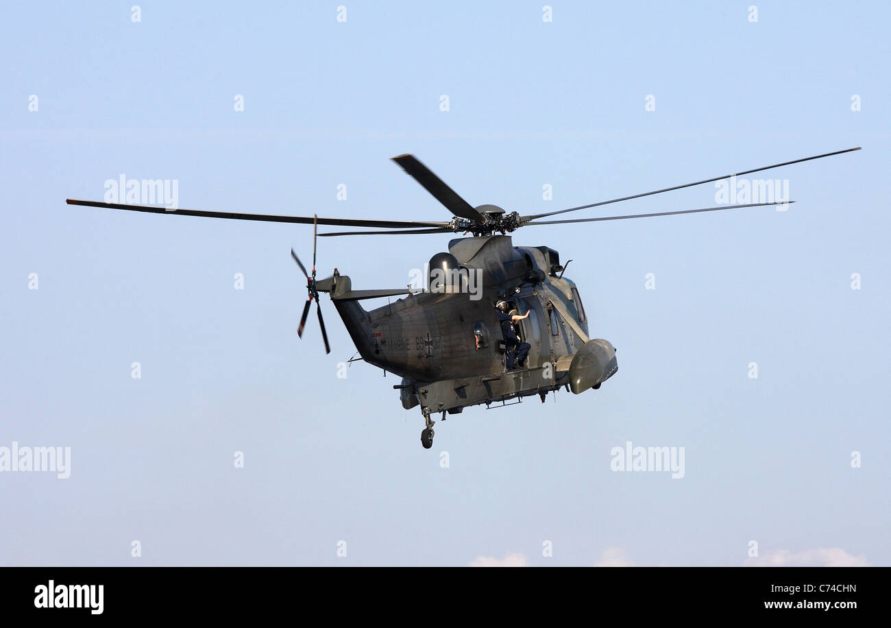 A navy helicopter in the air Stock Photo