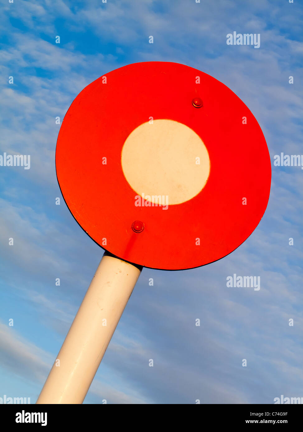Circular Winning Post sign with blue sky behind Stock Photo