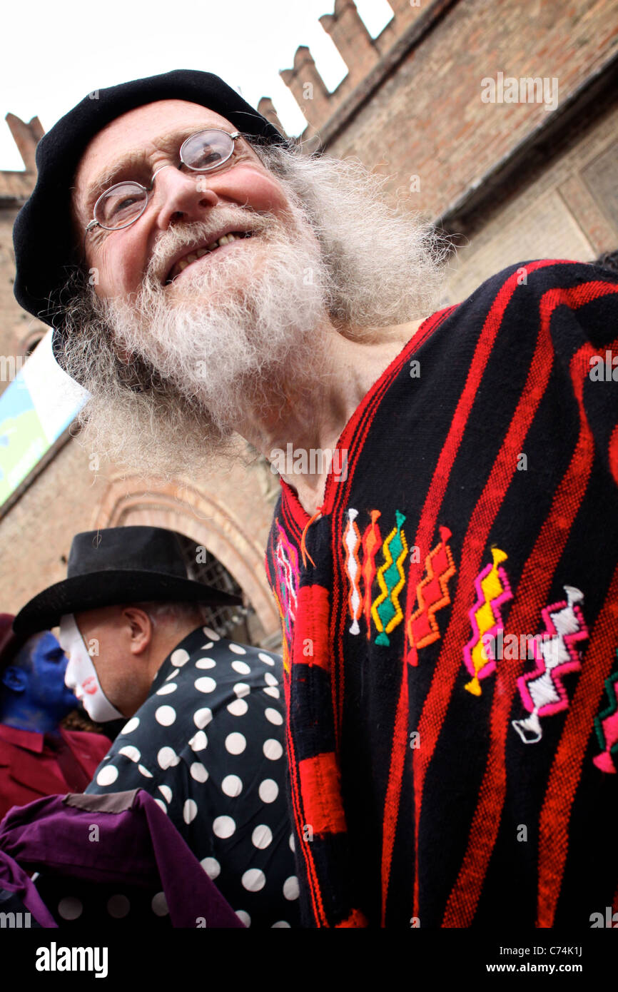 FESTIVAL: Old man dress like an hippie, long white beard, glasses, and red and black coat Stock Photo