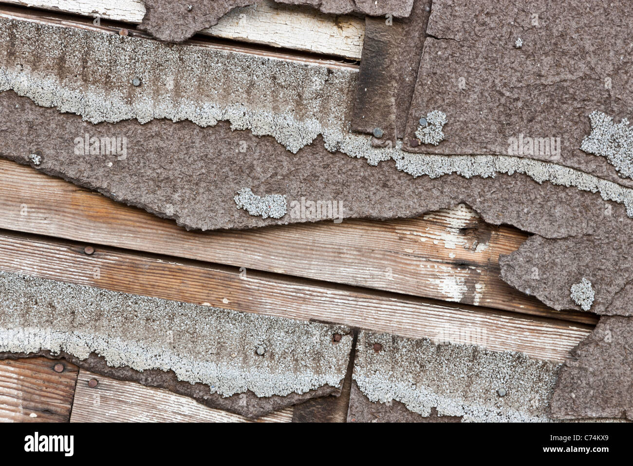 Asbestos composition asphalt shingles deteriorating Stock Photo