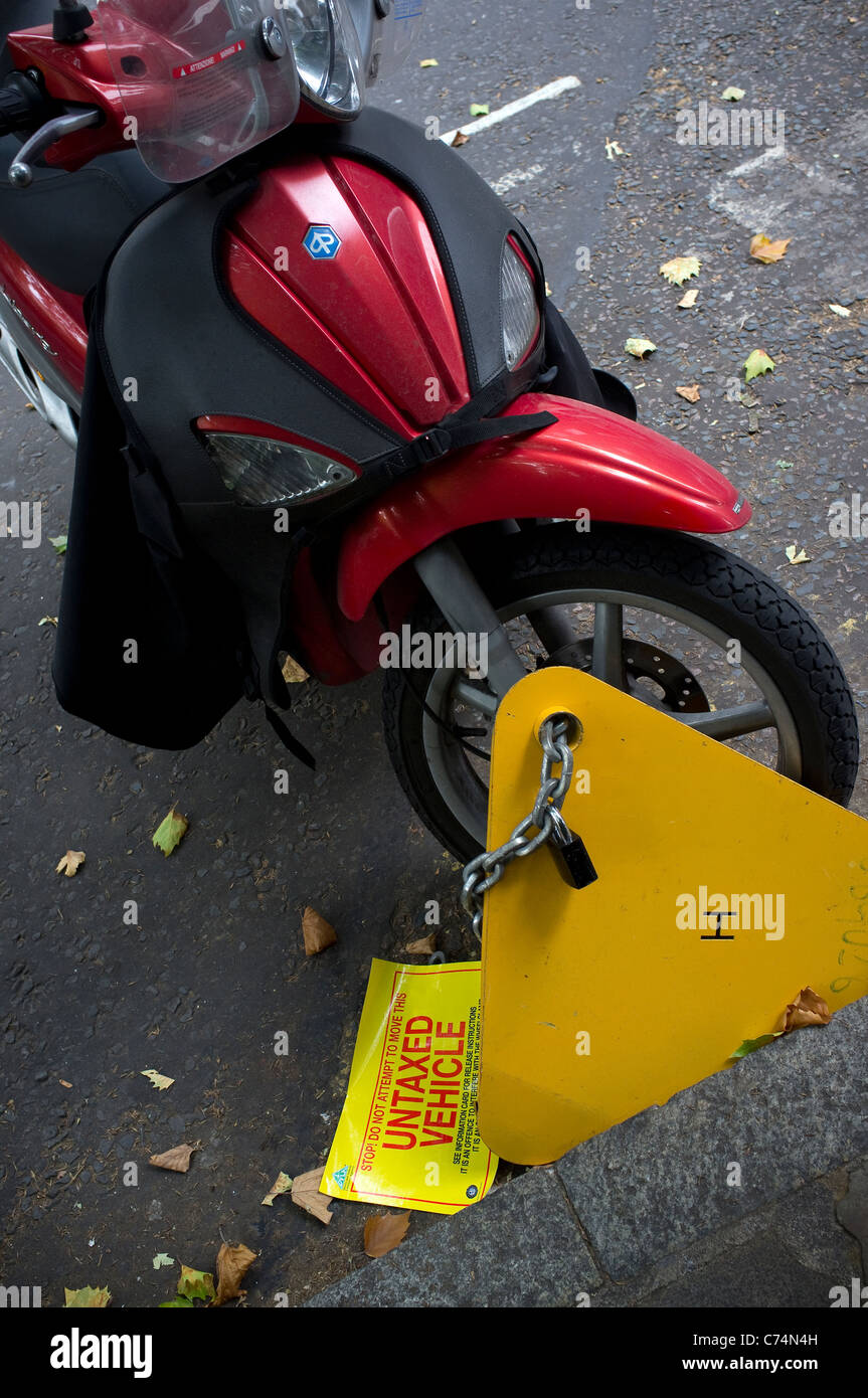 Clamped untaxed motorcycle Stock Photo