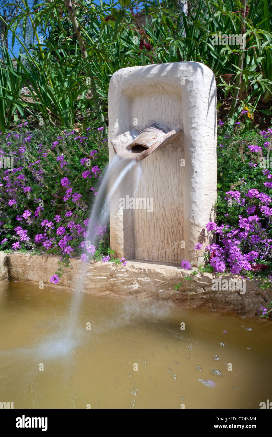 Stone Fountain or water feature in a Tuscan garden, Tuscany Italy Stock Photo
