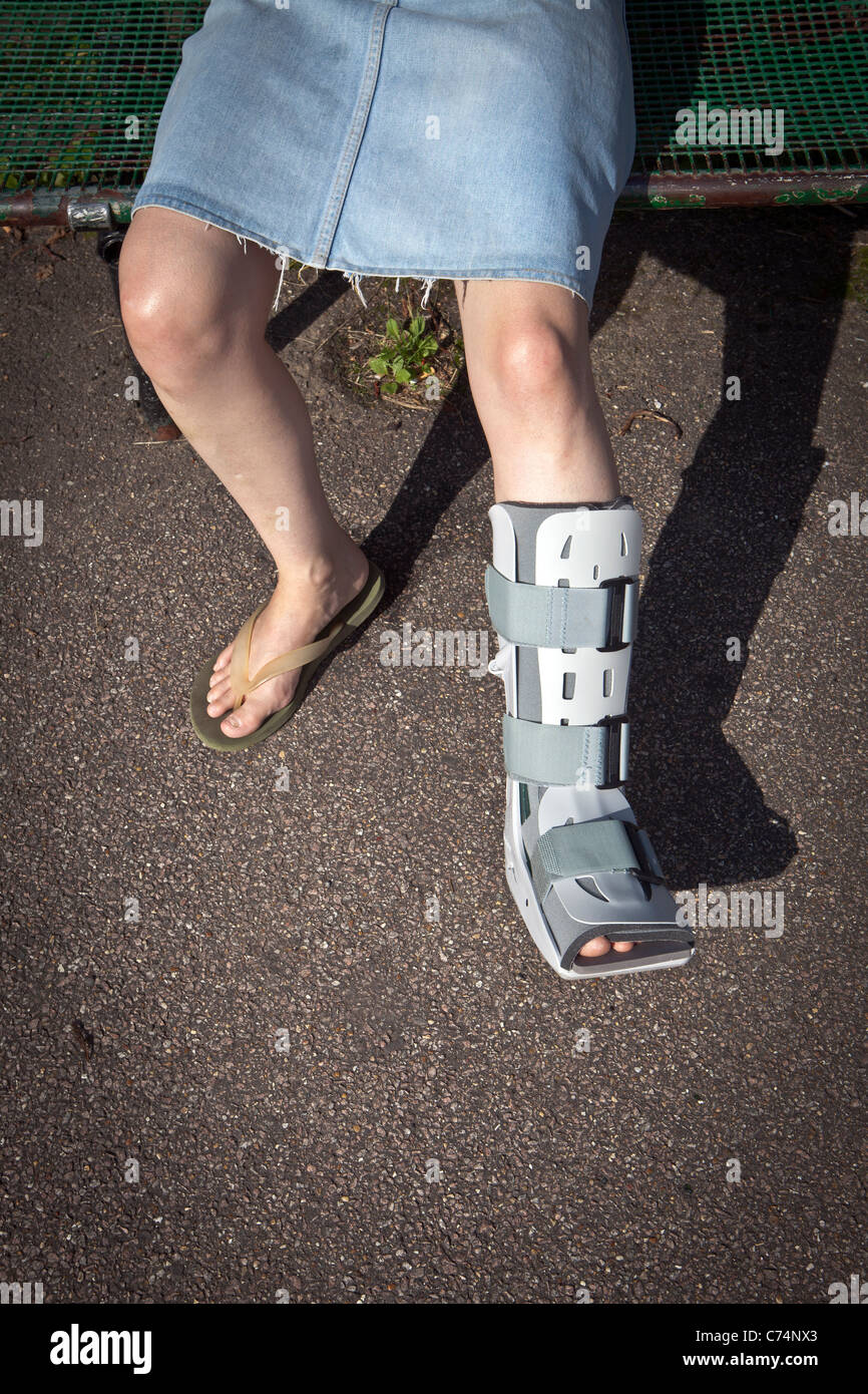 Broken foot in protective boot Stock Photo