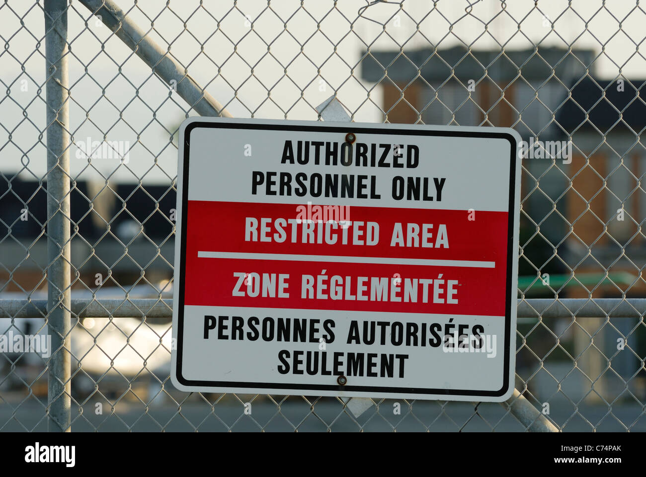 Bilingual warning sign attached chain hires stock photography and