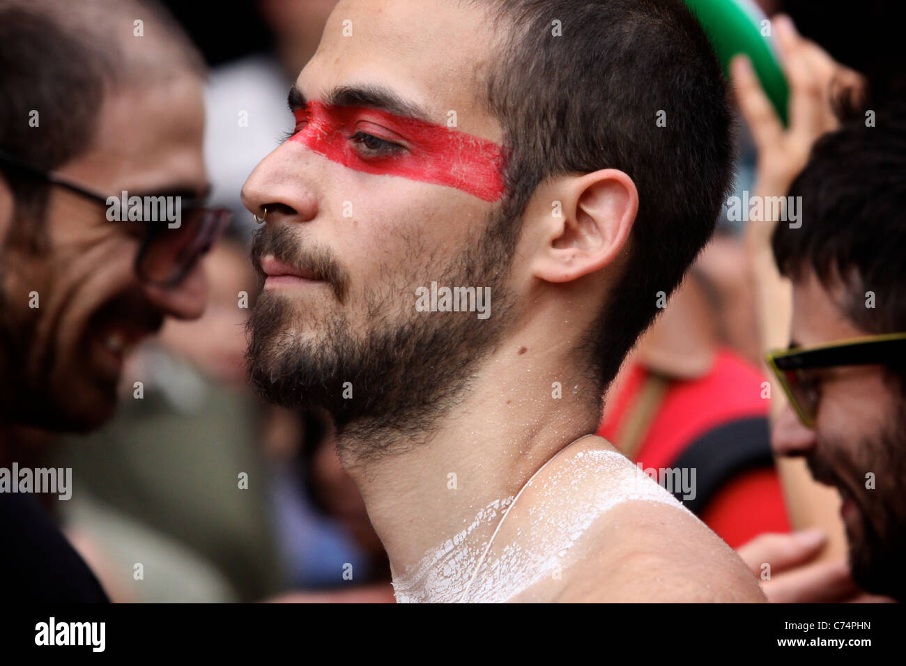 FESTIVAL: Face painted man dancing in the street parade, red eye Stock  Photo - Alamy