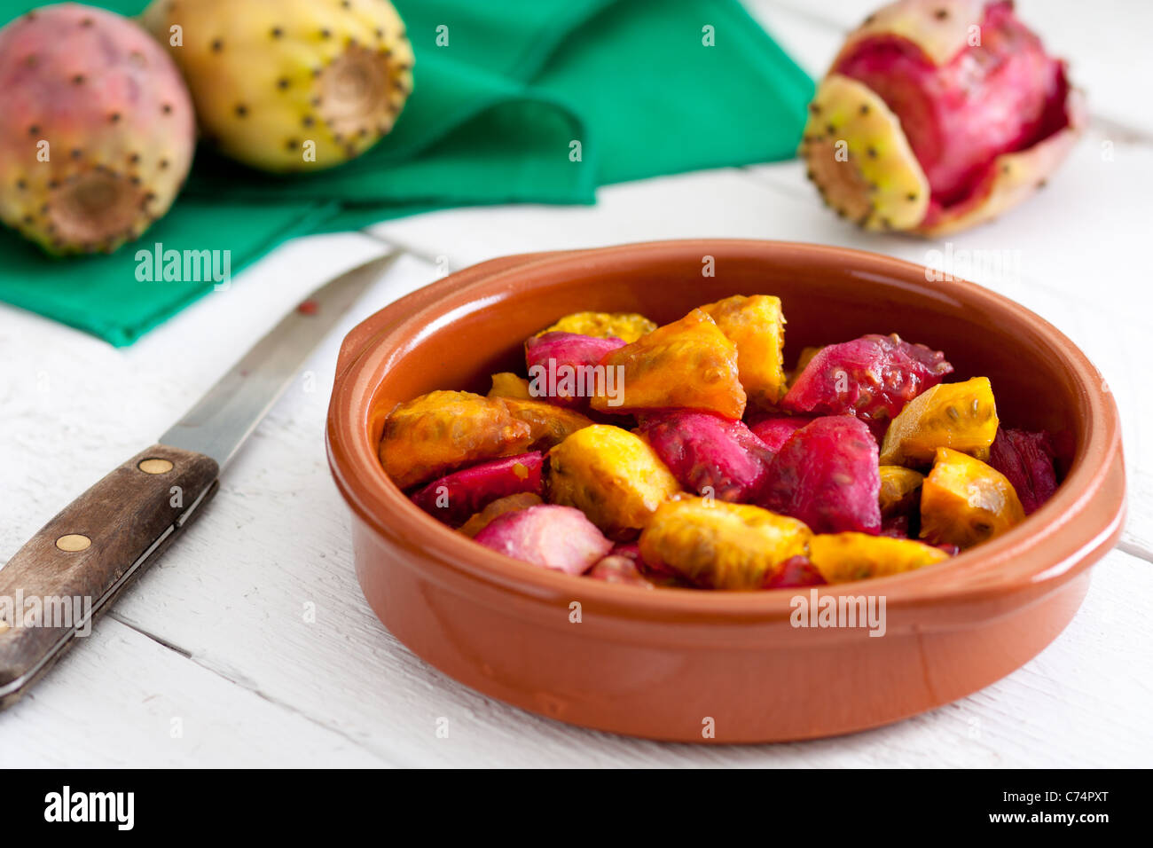 Sliced Indian Figs in a Bowl on White Wood Stock Photo