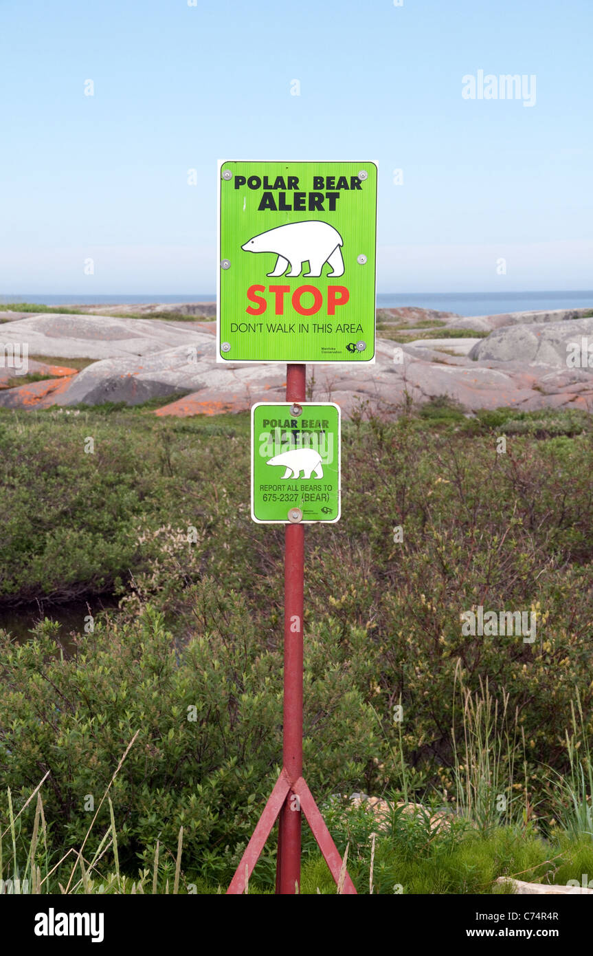 A polar bear warning sign in the tundra in 'bear alley' along the coast of Hudson Bay in the town of Churchill, Manitoba, Canada. Stock Photo
