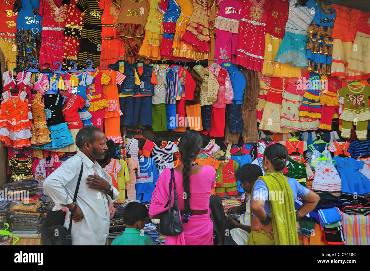 Selling children clothes on the shopping street Stock Photo Alamy