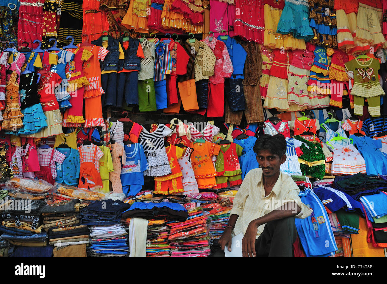 Man selling children clothes on the shopping street Stock Photo Alamy