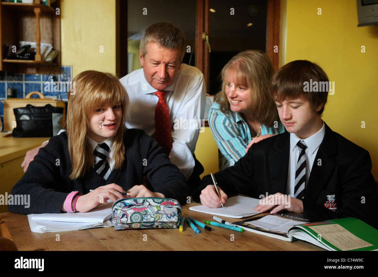 Parents watch as school children do their homework UK Stock Photo - Alamy