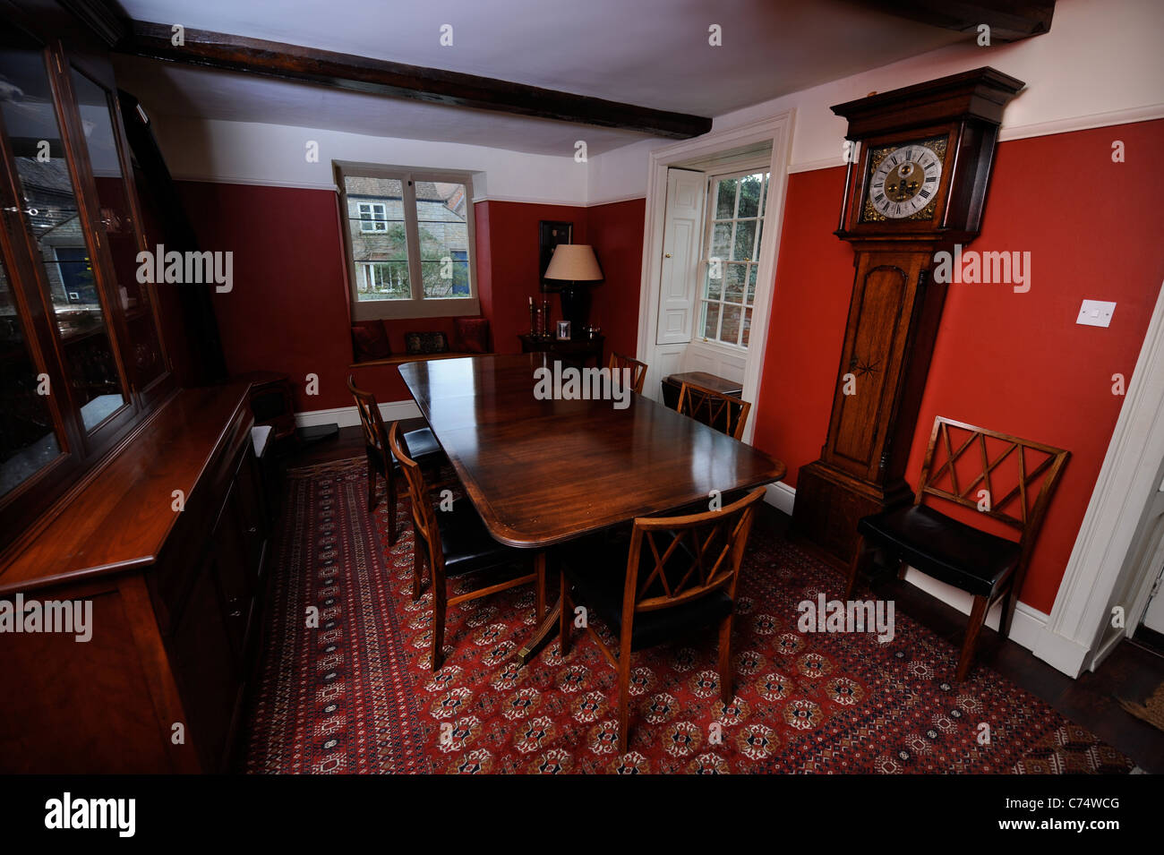 Traditional English country dining room with a grandfather clock UK Stock Photo