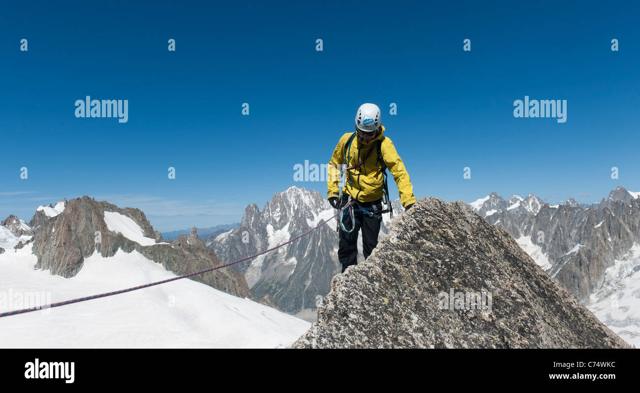 A mountain climber on the summit of Pyramide du Tacul, near Chamonix, France Stock Photo