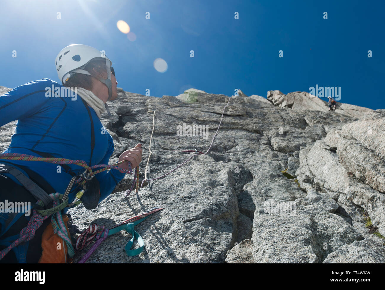 A belayer belaying his climbing partner on the granite of Pyramide du