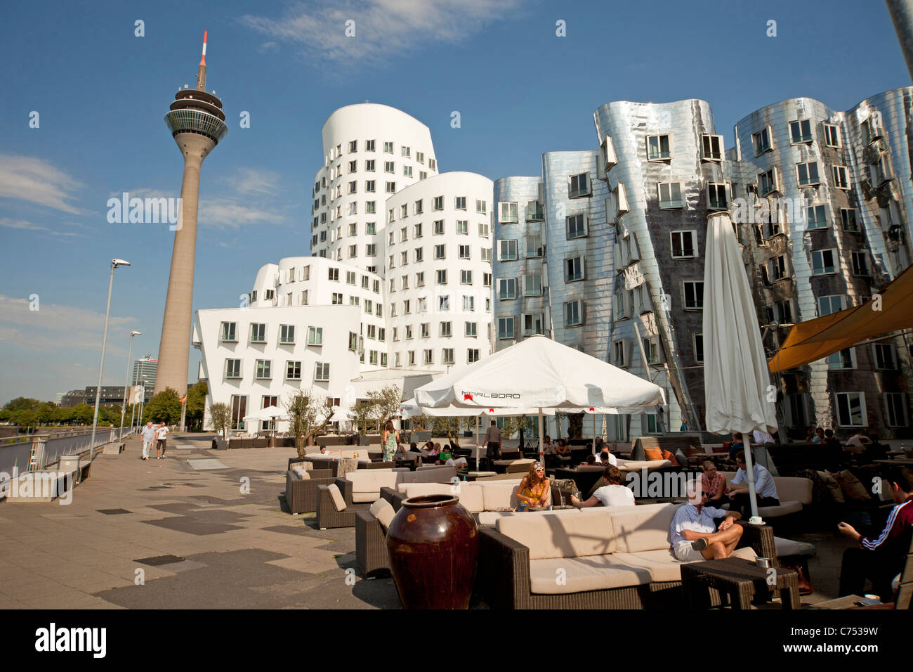 The Neue Zollhof  designed by  architect Frank O. Gehry of Media Harbor and Rheinturm telecommunications tower in Duesseldorf, Stock Photo