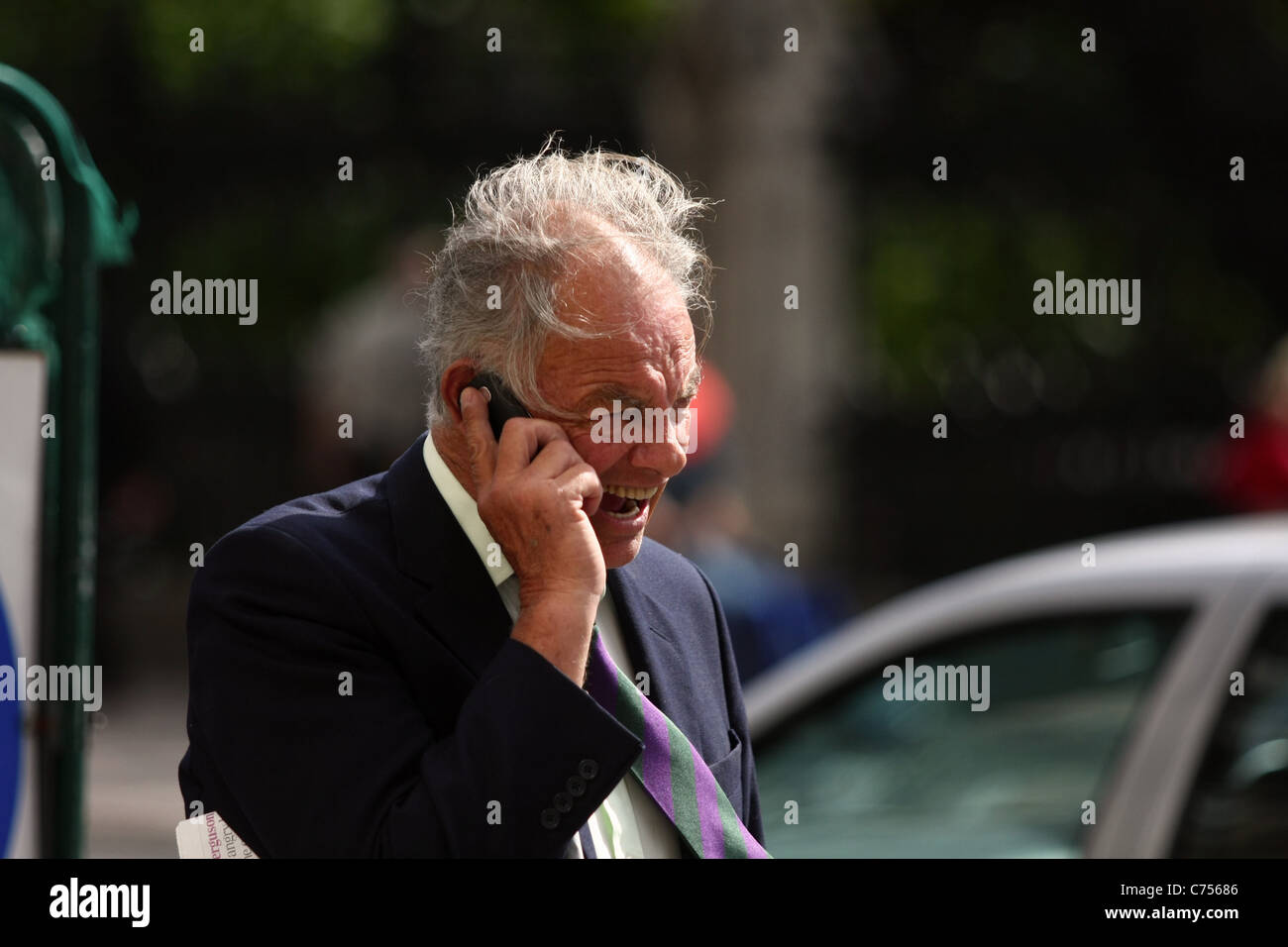 a mature businessman using a mobile phone in a street Stock Photo - Alamy