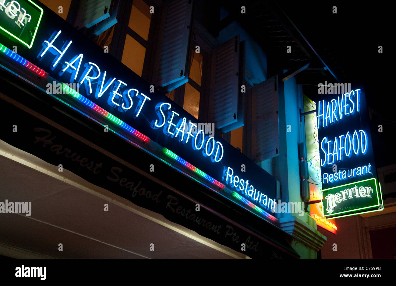 Neon lit signs for seafood restaurants, Boat Quay, Singapore asia Stock Photo