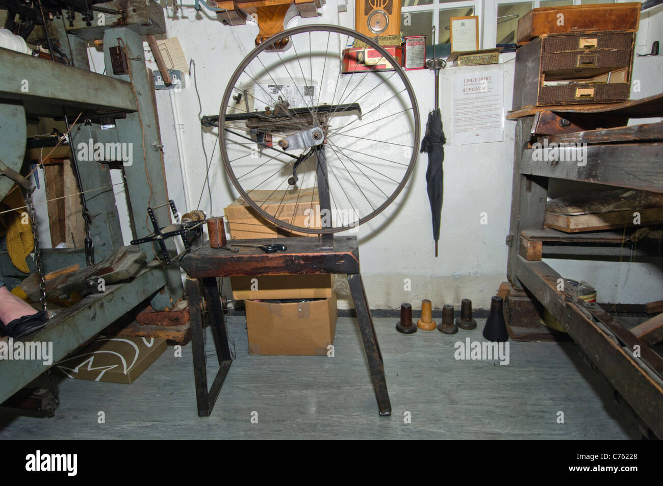 A vintage wool winder fashioned from a bicycle wheel and wooden saw-type bench. Stock Photo