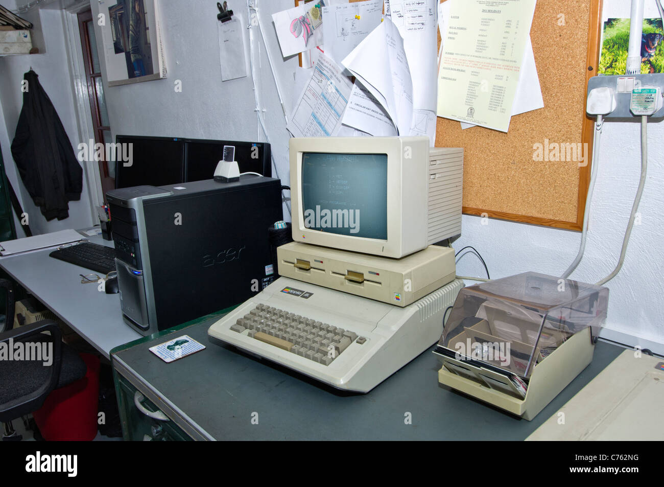 An Apple IIe computer still in use in knitting business, driving Stoll  flatbed knitting machine. Alongside is a modern Acer PC Stock Photo - Alamy