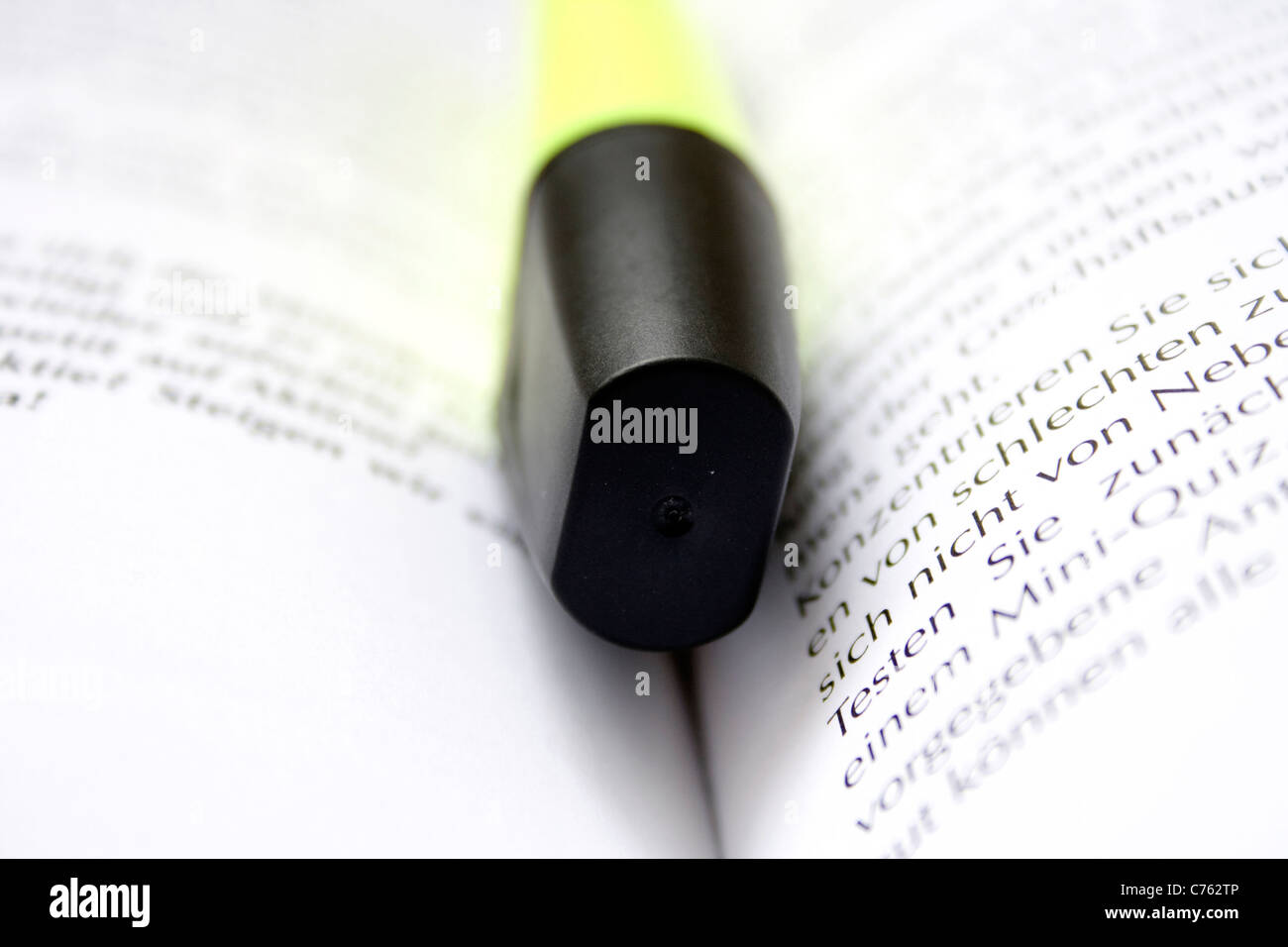 Yellow Highlighter on a white book background Stock Photo