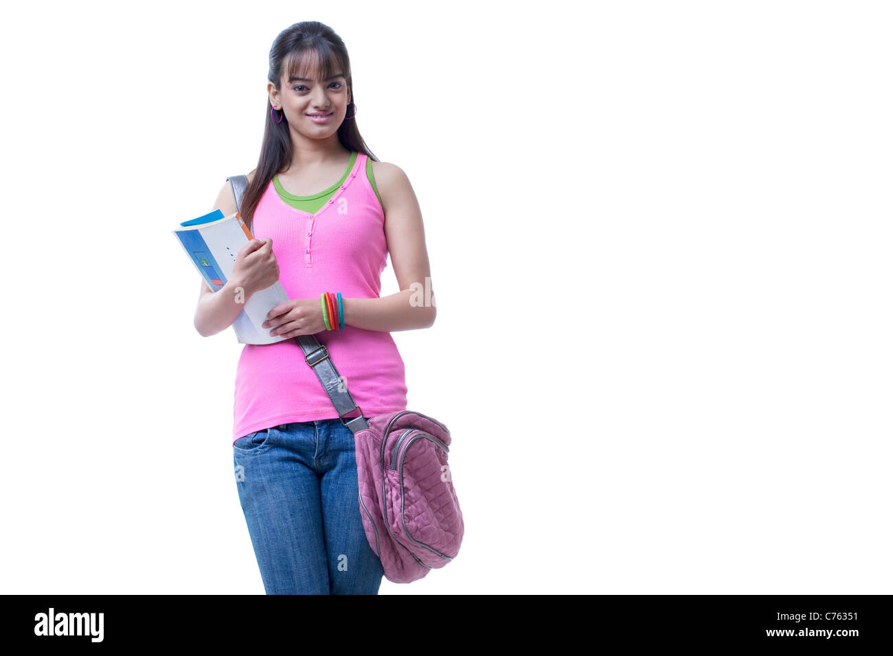 Happy university student holding books over white background Stock Photo