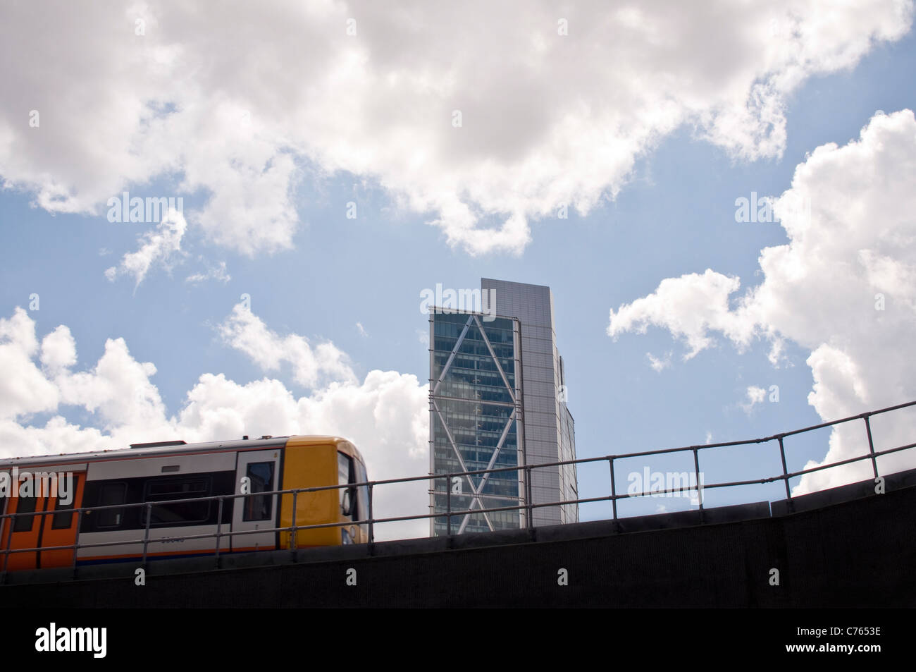 A train on the new East London Line extension passing through Shoreditch, Hackney. Broadgate Tower is visible in the background. Stock Photo