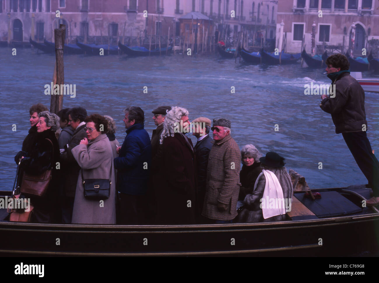 Local People in a Traghetto cross the Grand Canal during The Carnival, Venice, Italy Stock Photo