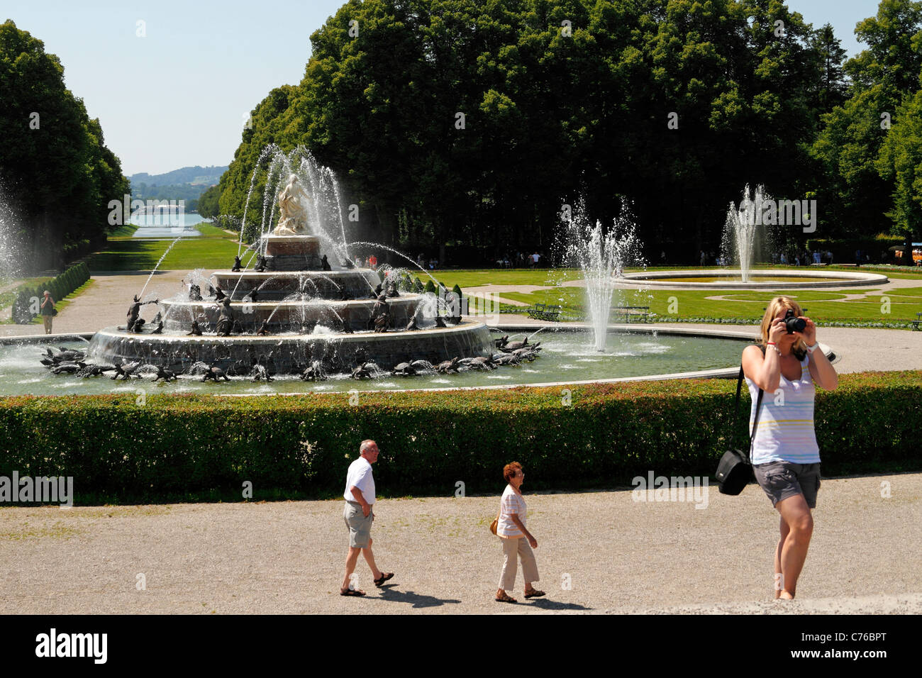 Woman taking a photo in front of the Latona Fountain, Herrenchiemsee Herreninsel Upper Bavaria Germany Stock Photo