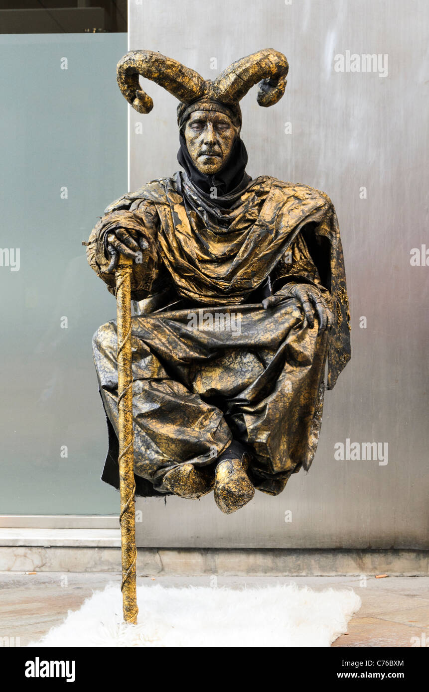 Street performer dressed as the devil levitating - Coruna, Galicia, Spain Stock Photo