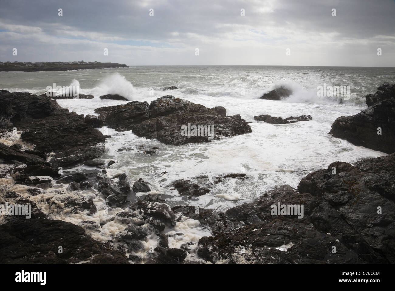 Trearddur Bay, Anglesey, North Wales, UK. Rough sea with waves crashing on rocks during gale force winds on the west coast. Stock Photo
