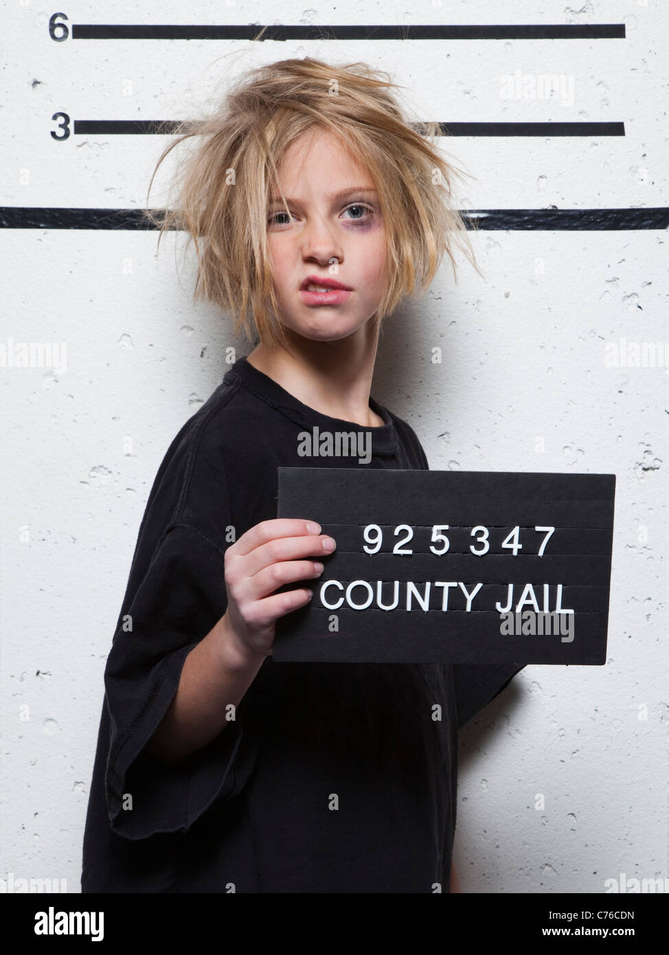 Studio mugshot of girl (8-9) with tousled hair Stock Photo