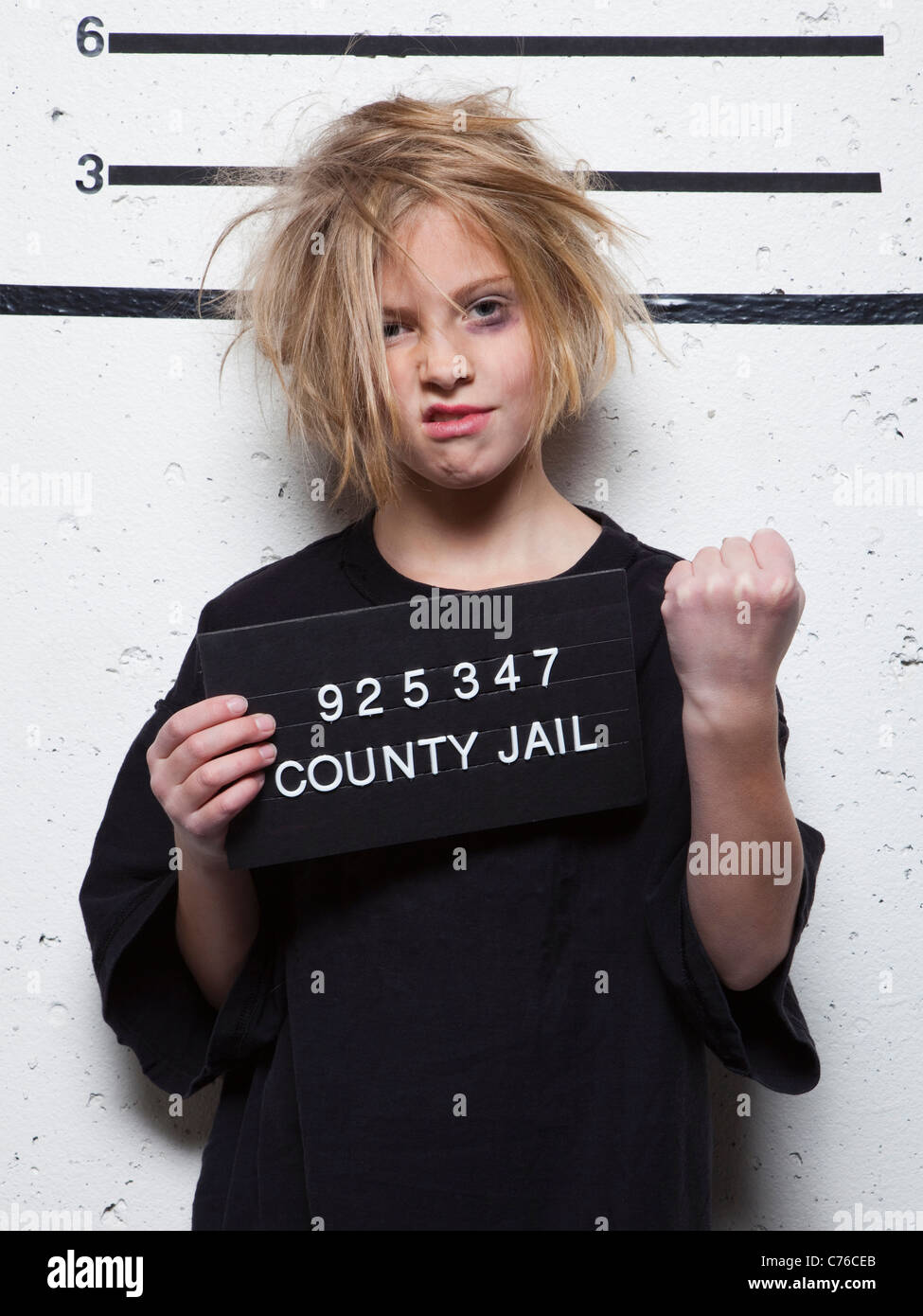 Studio mugshot of girl (8-9) with tousled hair Stock Photo