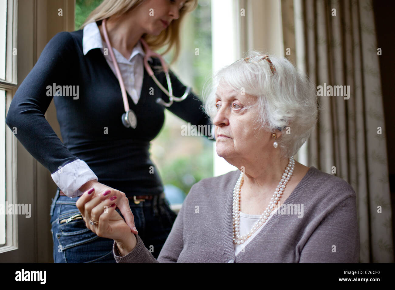 Doctor Checks Up on Elderly Lady Stock Photo